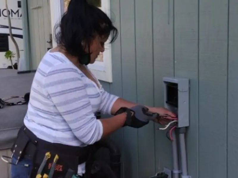 Licensed electrician wiring an exterior subpanel in Wildwood